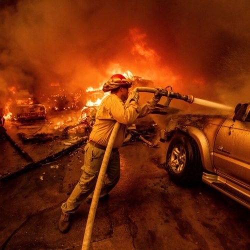 A firefighter battles the Eaton Fire Wednesday, Jan. 8, 2025 in Altadena, Calif. (AP Photo/Ethan Swope)